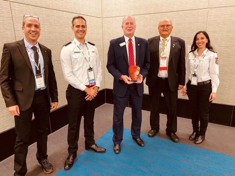 Guy Mor in fire authority uniform (Colonel) attending a strategic coordination meeting regarding fire safety regulations.
